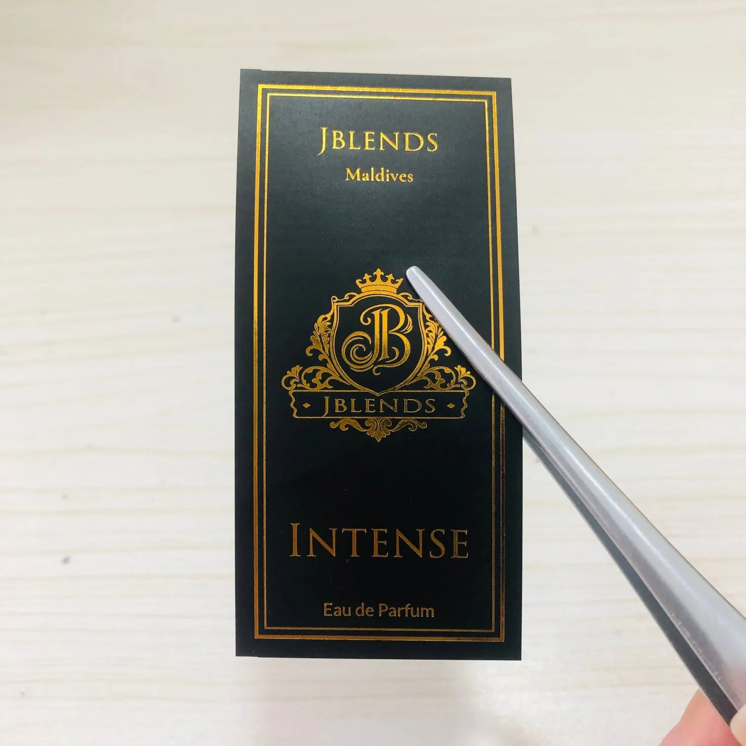 What finishing techniques work best alongside hot stamping for perfume label design